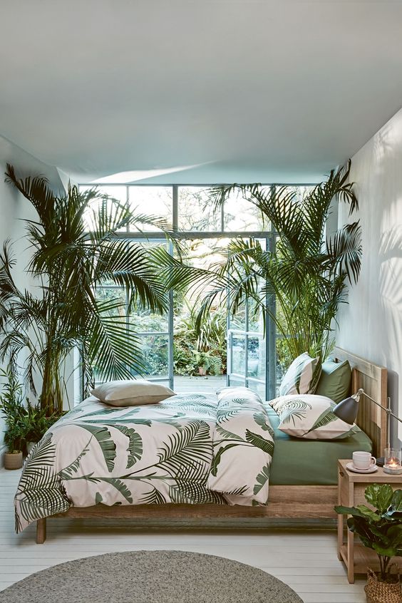 Airy and refreshing space of a tropical bedroom by making use of soft green and white palette